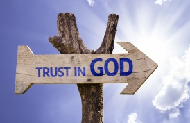 Trust in God wooden sign on a beautiful day