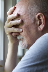 Older man expressing pain or depression, vertical